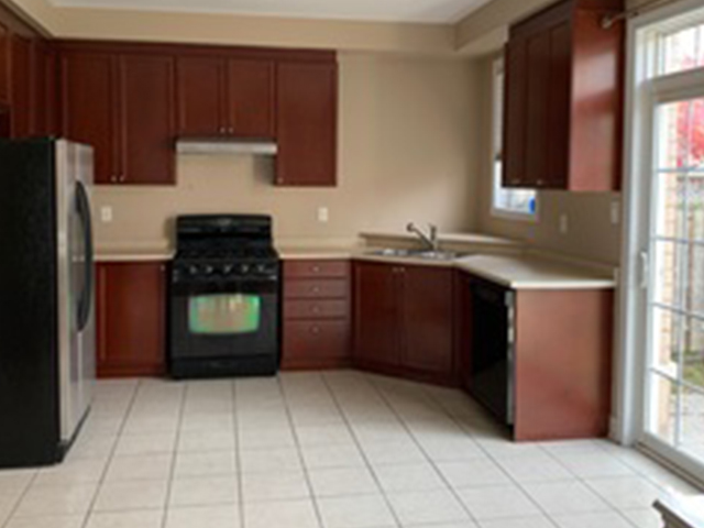 Kitchen with appliances and light tile floors