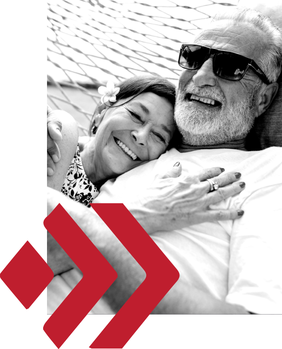 Smiling senior couple relaxing on a hammock swing